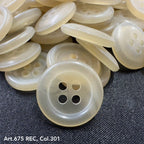 Wholesale four-hole buttons in translucent cream color by Buttonology Inc, stacked on dark fabric