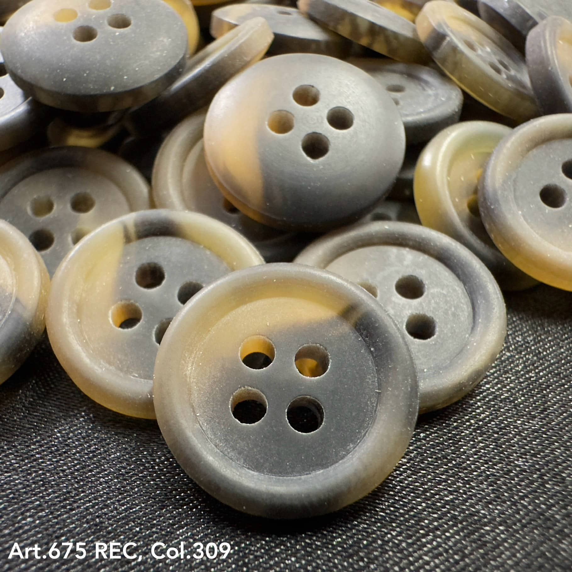 Wholesale four-hole buttons by Buttonology Inc in gray and beige tones with smooth matte finish