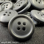 Wholesale four-hole buttons by Buttonology Inc in black with a matte finish close-up image