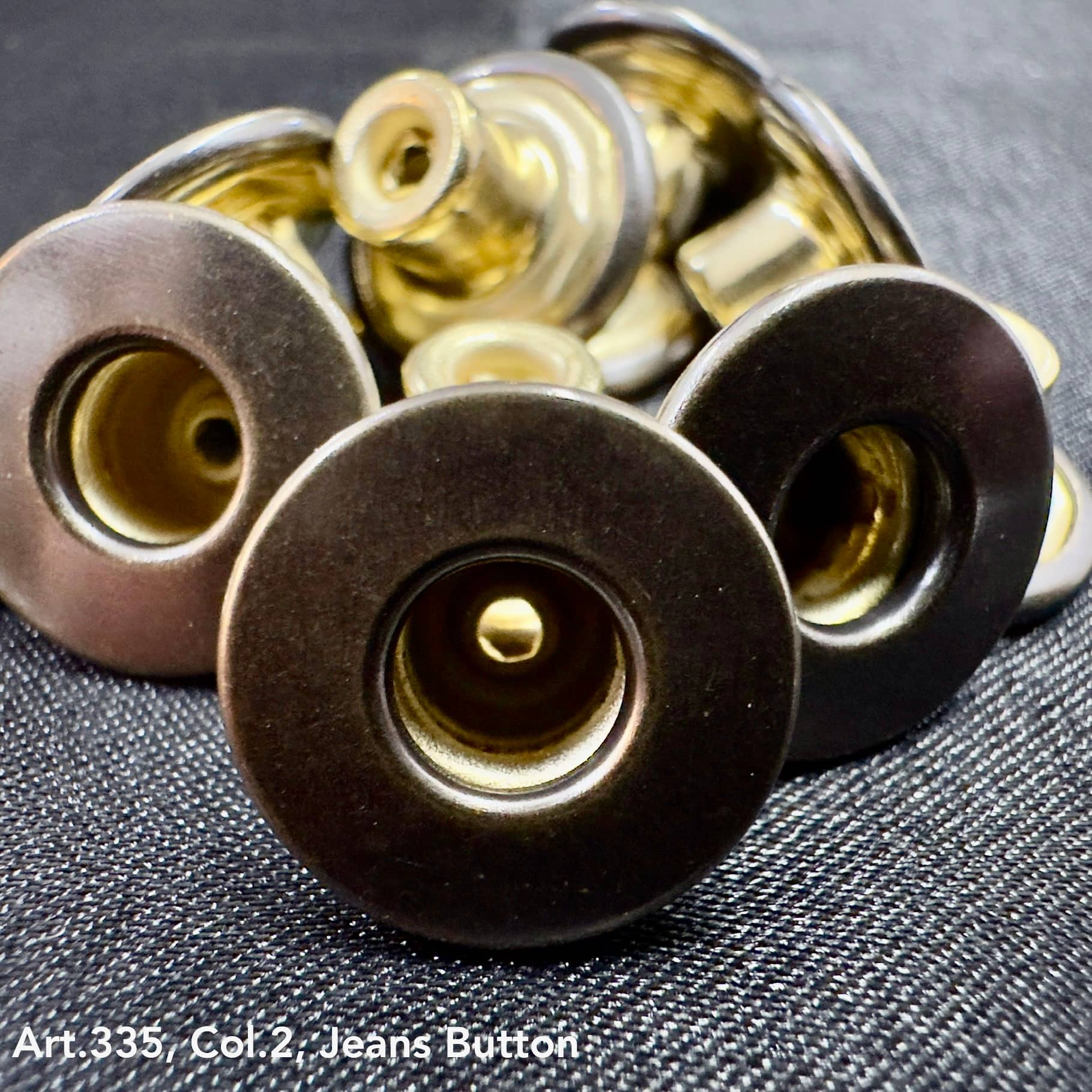 Close-up of metal jean buttons from Buttonology Inc wholesale jean button supply