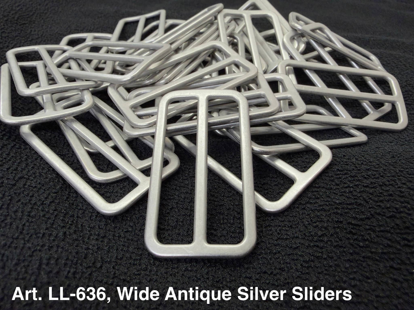 Art LL-636 Wide Antique Silver Sliders in a pile, perfect for crafts and clothing projects