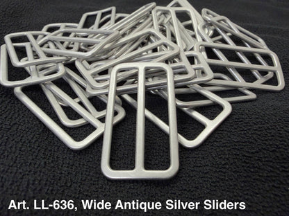 Art LL-636 Wide Antique Silver Sliders in a pile, perfect for crafts and clothing projects